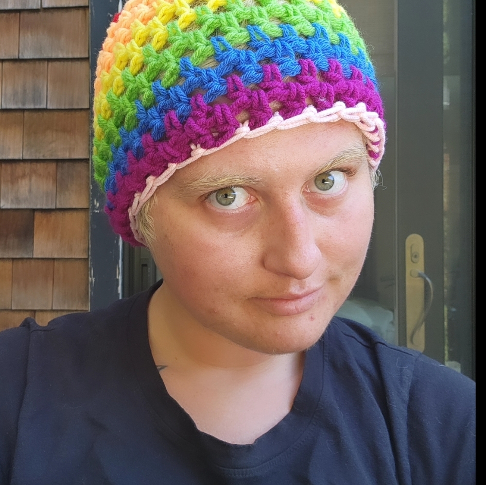 Rainbow hat with pink glow in the dark rim